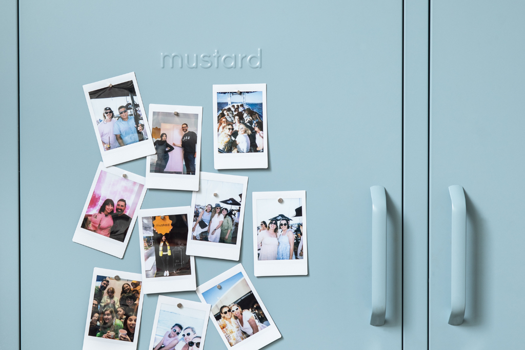 A collection of polaroids are stuck to the front of an Ocean locker door.